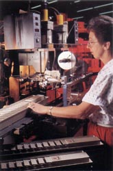 A worker demonstrating decorative hot stamping.